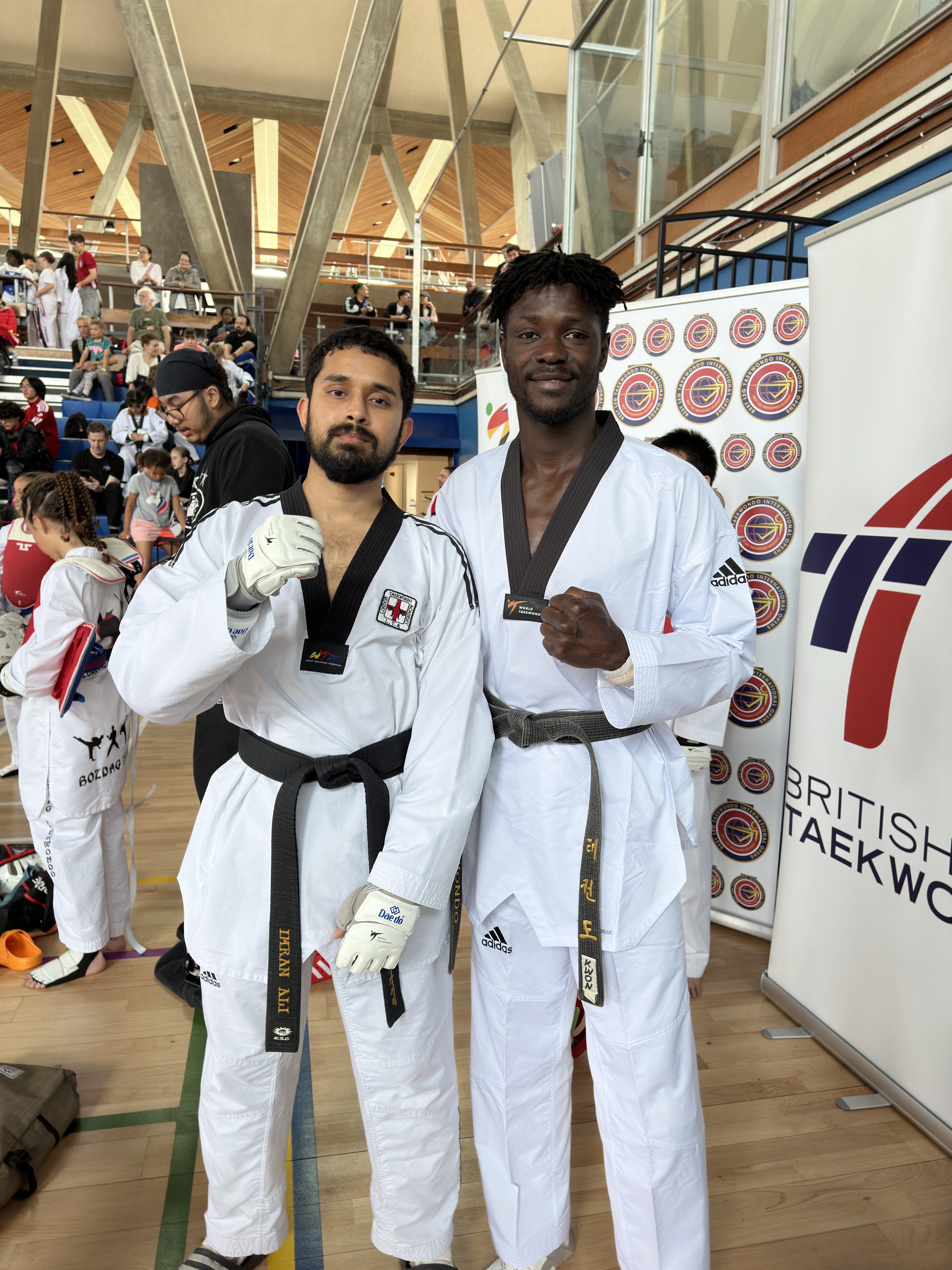 Two black belt fighters at a British Taekwondo open